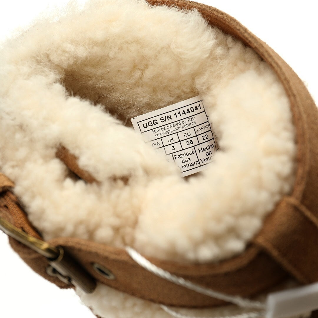 Close-up of a UGG boot with a visible label on a white background