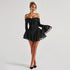 Chic minimalist black playsuit styled with heels