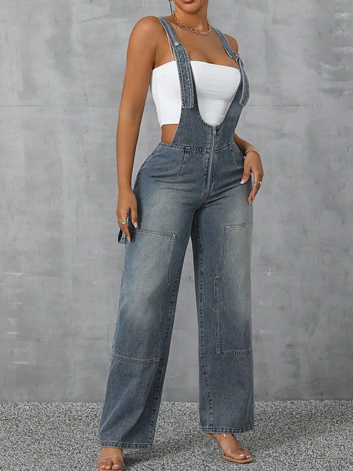 Confident woman in wide-strap zip-front denim overalls – ODI-ONE FASHION
