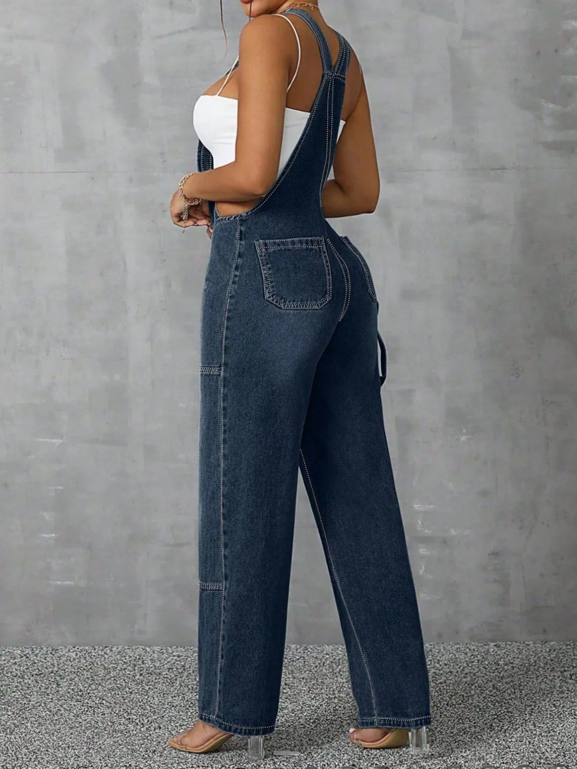 Confident woman in wide-strap zip-front denim overalls – ODI-ONE FASHION
