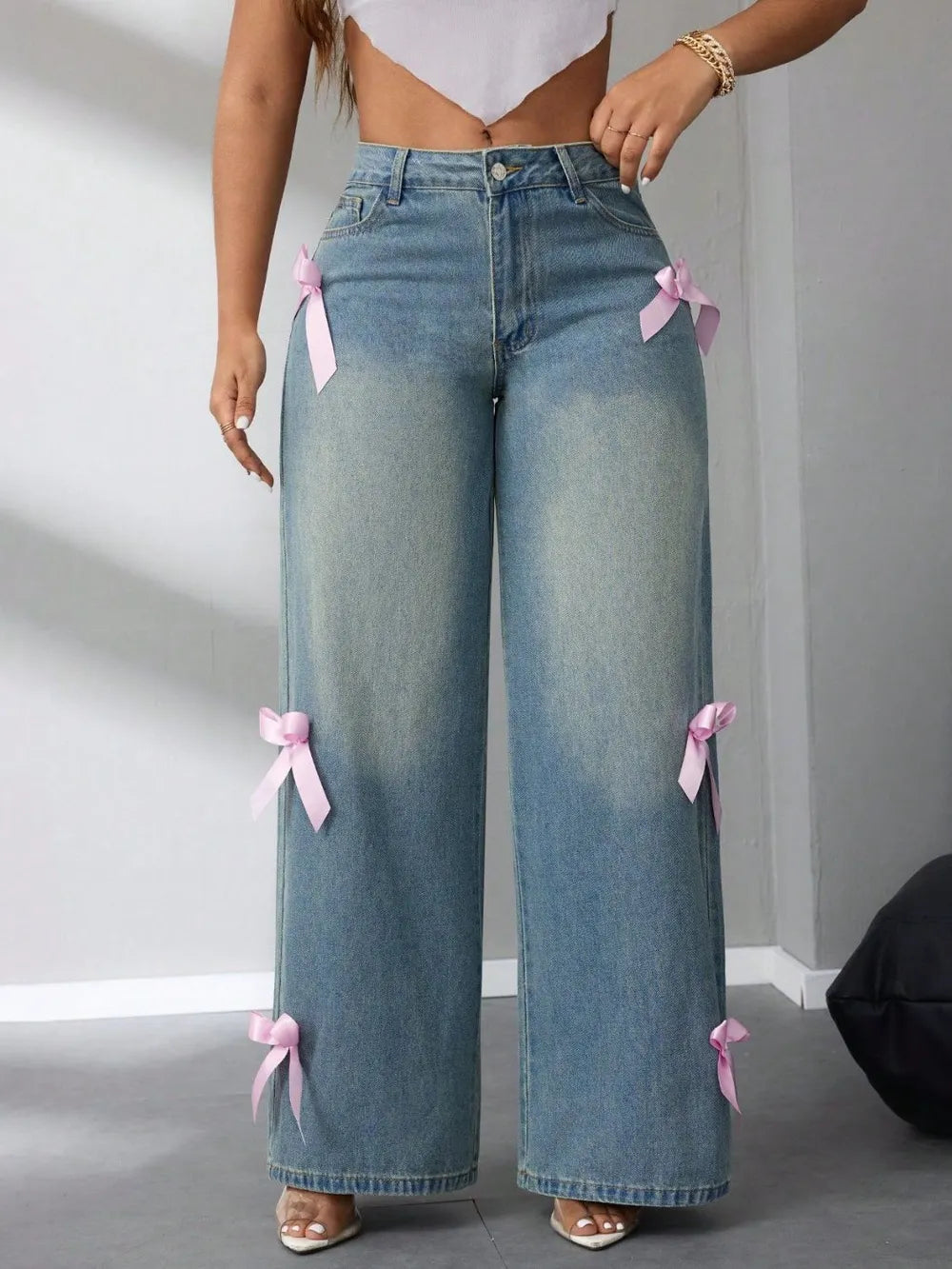Model wearing high-rise wide leg jeans with bow detail at waist – ODI-ONE FASHION