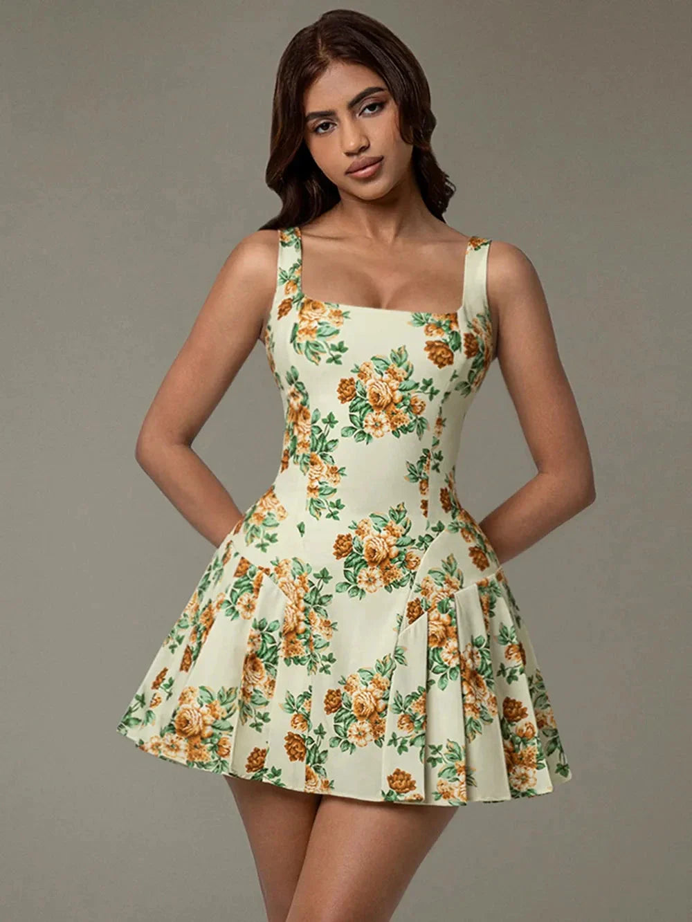 Flat lay view of sleeveless pleated mini dress with floral print – Blossom Breeze dress Blossom Breeze Mini Dress