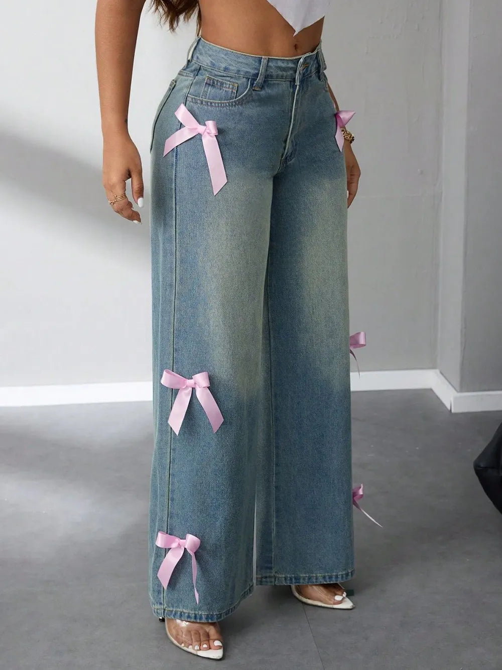 Model wearing high-rise wide leg jeans with bow detail at waist – ODI-ONE FASHION