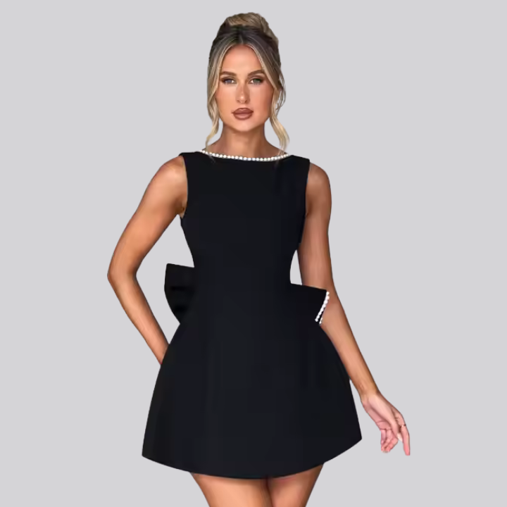 Model wearing Celestine backless mini dress with pearl bow detail – ODI-ONE FASHION
