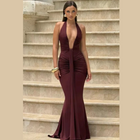 Model wearing deep V-neck ruched backless maxi dress
