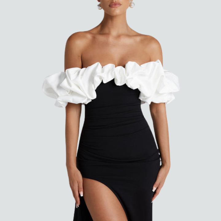 Model wearing Noirel black and white maxi dress – full length elegance | ODI-ONE FASHION

