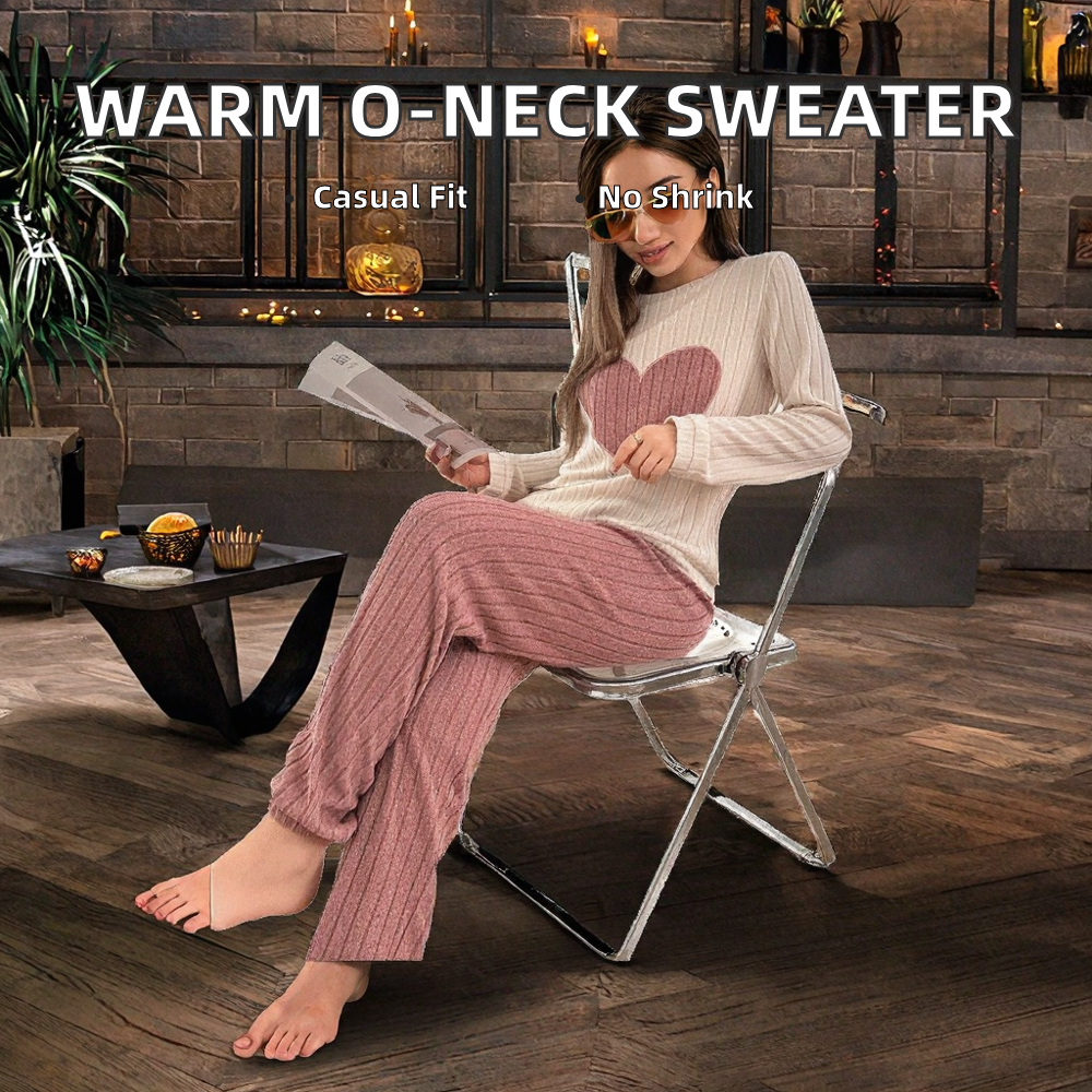 Woman wearing a warm o-neck sweater and pink pants sitting on a chair indoors.