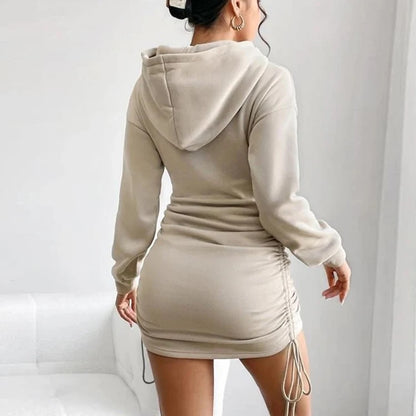 Beige hoodie dress worn by a person on a white background