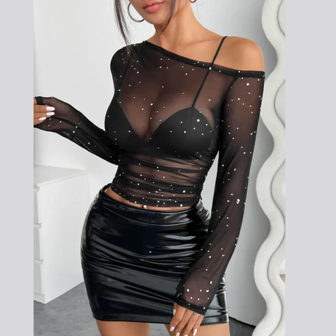 Woman wearing a one-shoulder mesh long sleeve top in a sleek, stylish outfit
