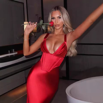Woman in a red dress holding a rose in a modern indoor setting