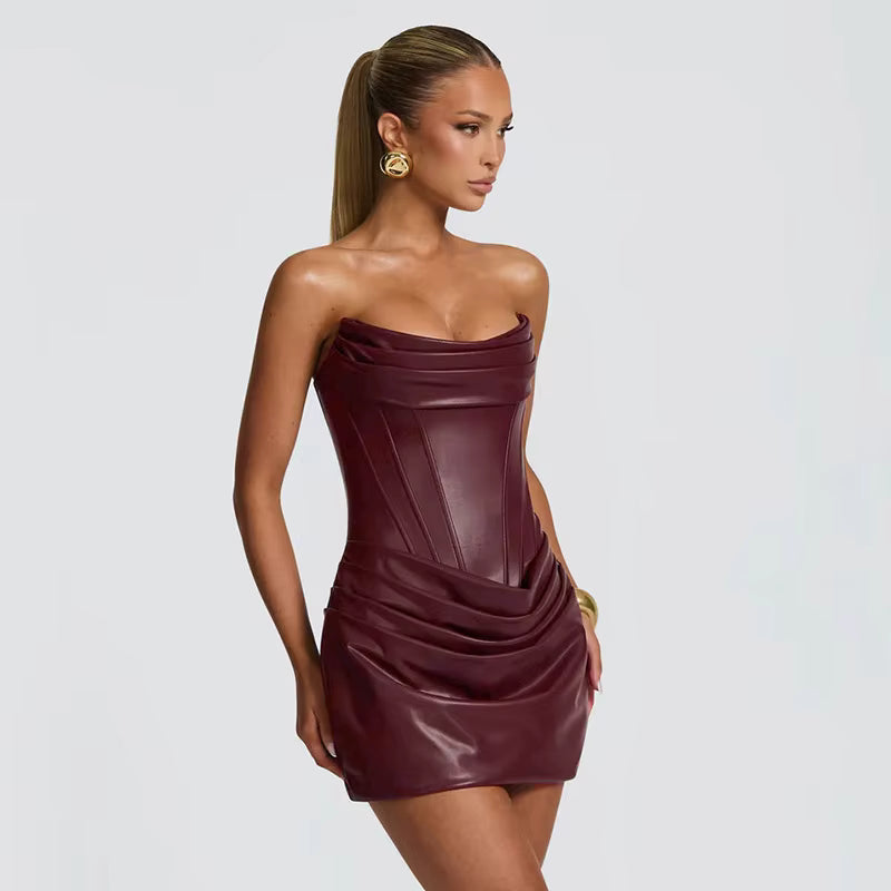 Woman wearing a strapless burgundy dress on a light gray background