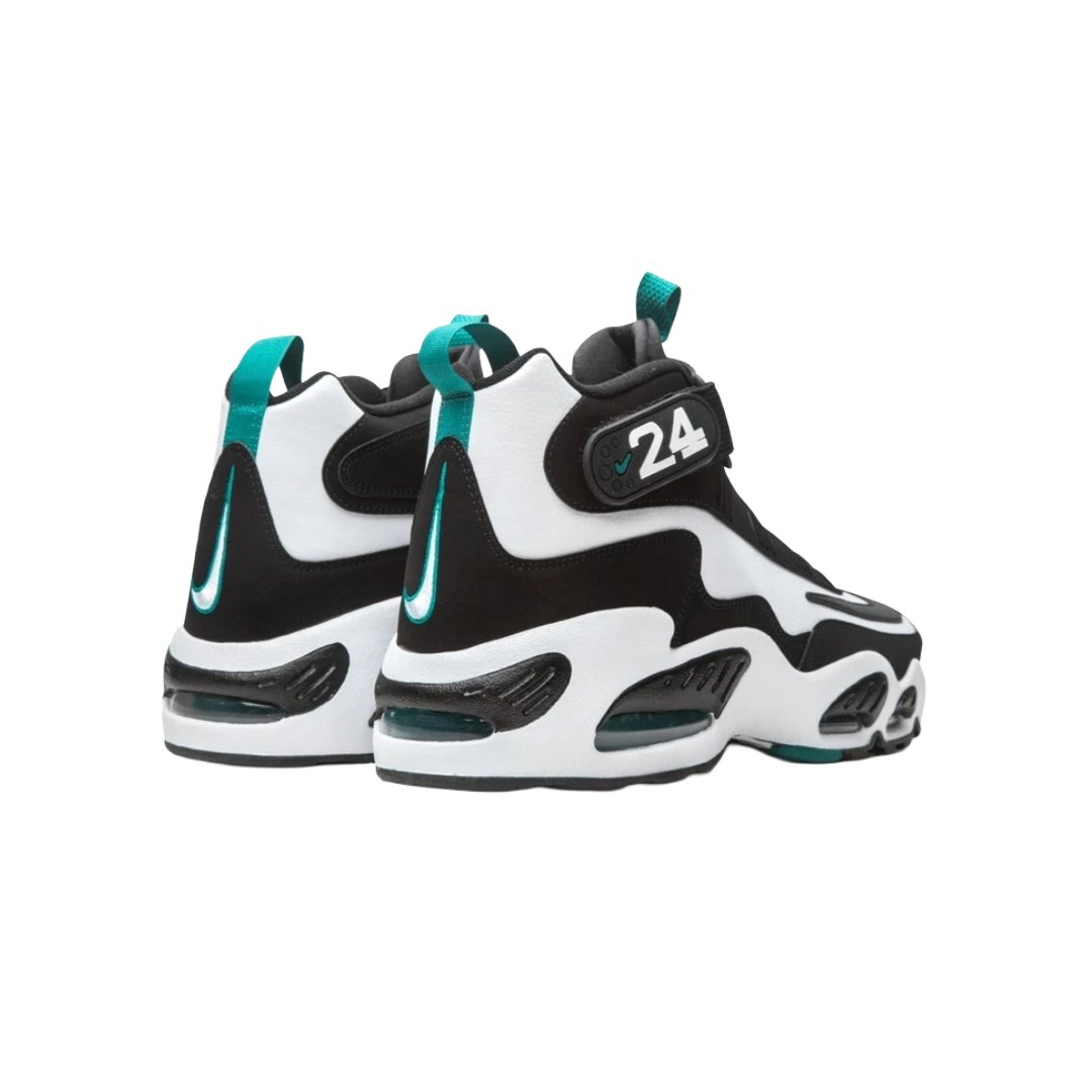 Black and white sneakers with teal accents on a white background