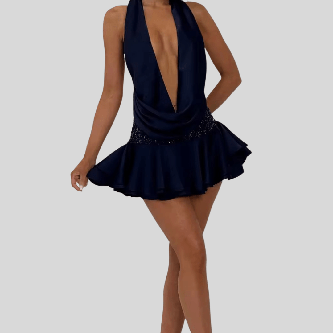 Navy blue dress with a plunging neckline and beaded details on a gray background