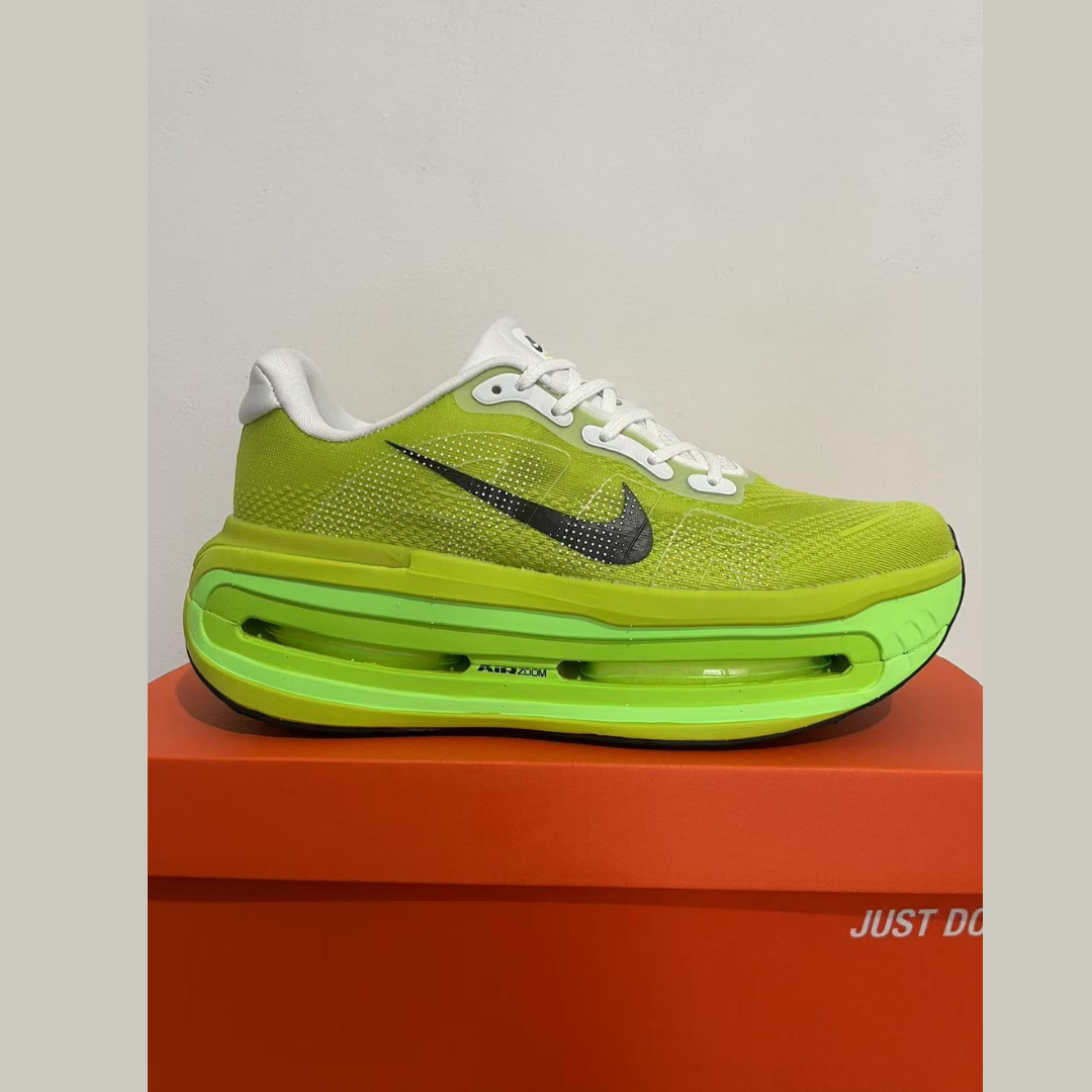 Green Nike sneaker on an orange box with 'Just Do It' text