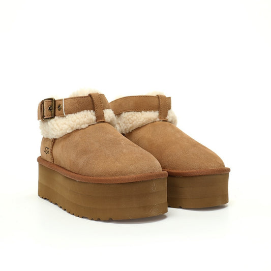 Pair of brown suede platform boots with white fur lining on a white background