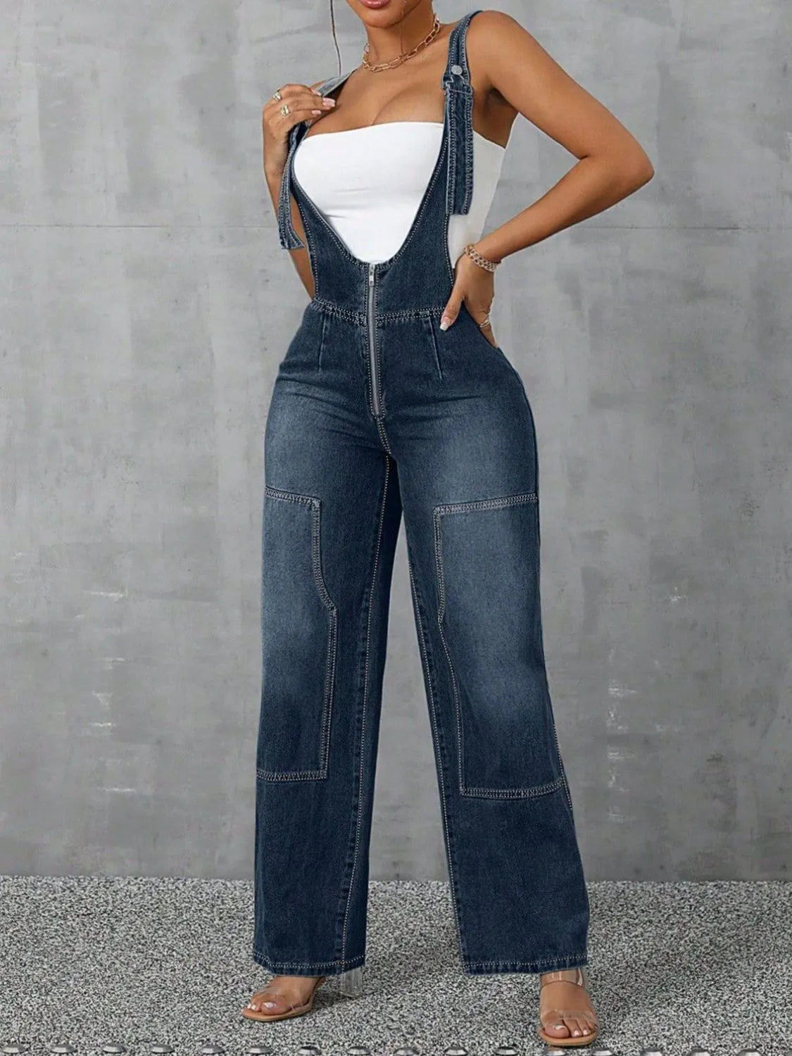 Confident woman in wide-strap zip-front denim overalls – ODI-ONE FASHION
