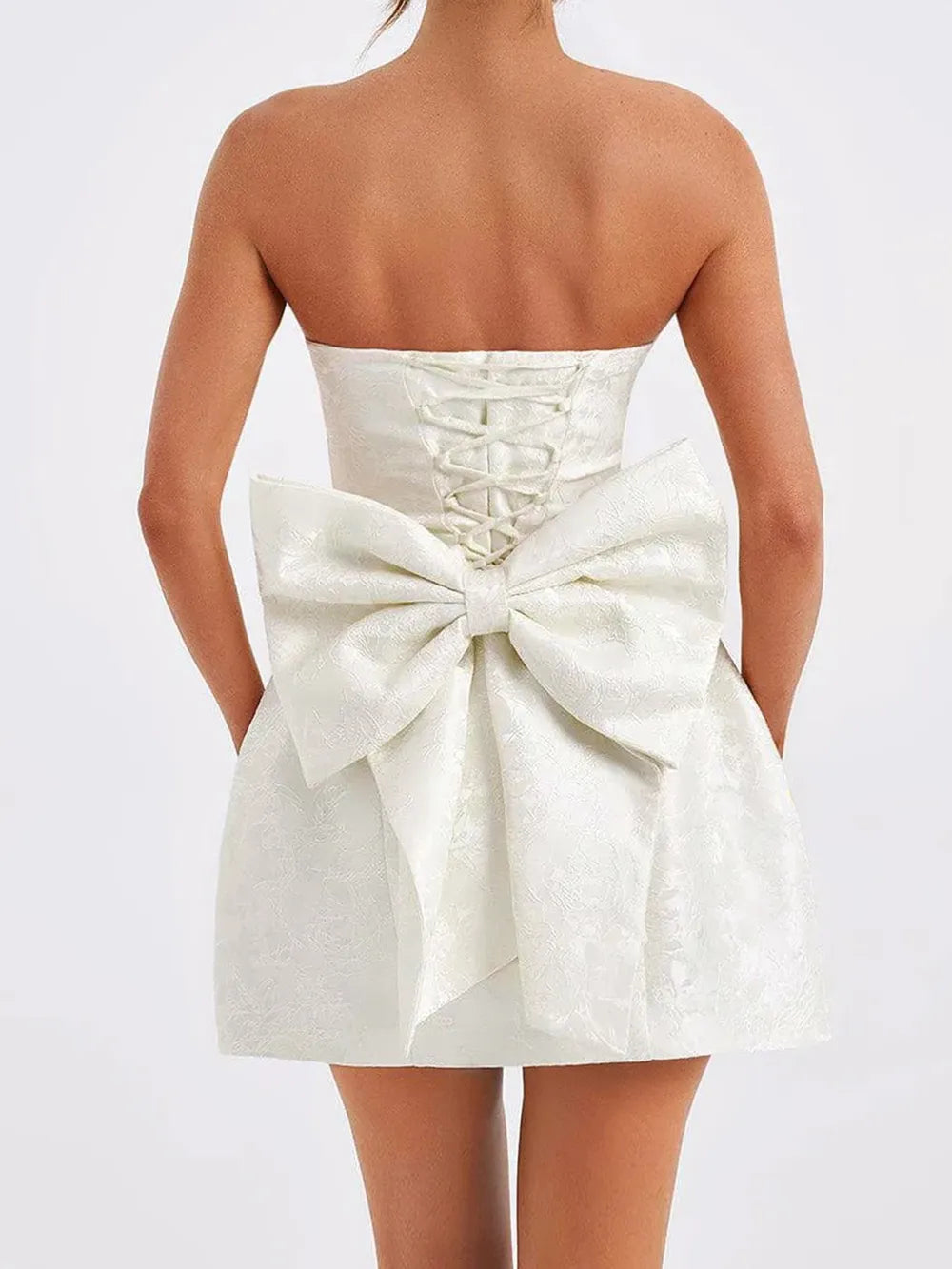 Close-up of satin fabric and bow detail on mini dress Silky Desire Dress