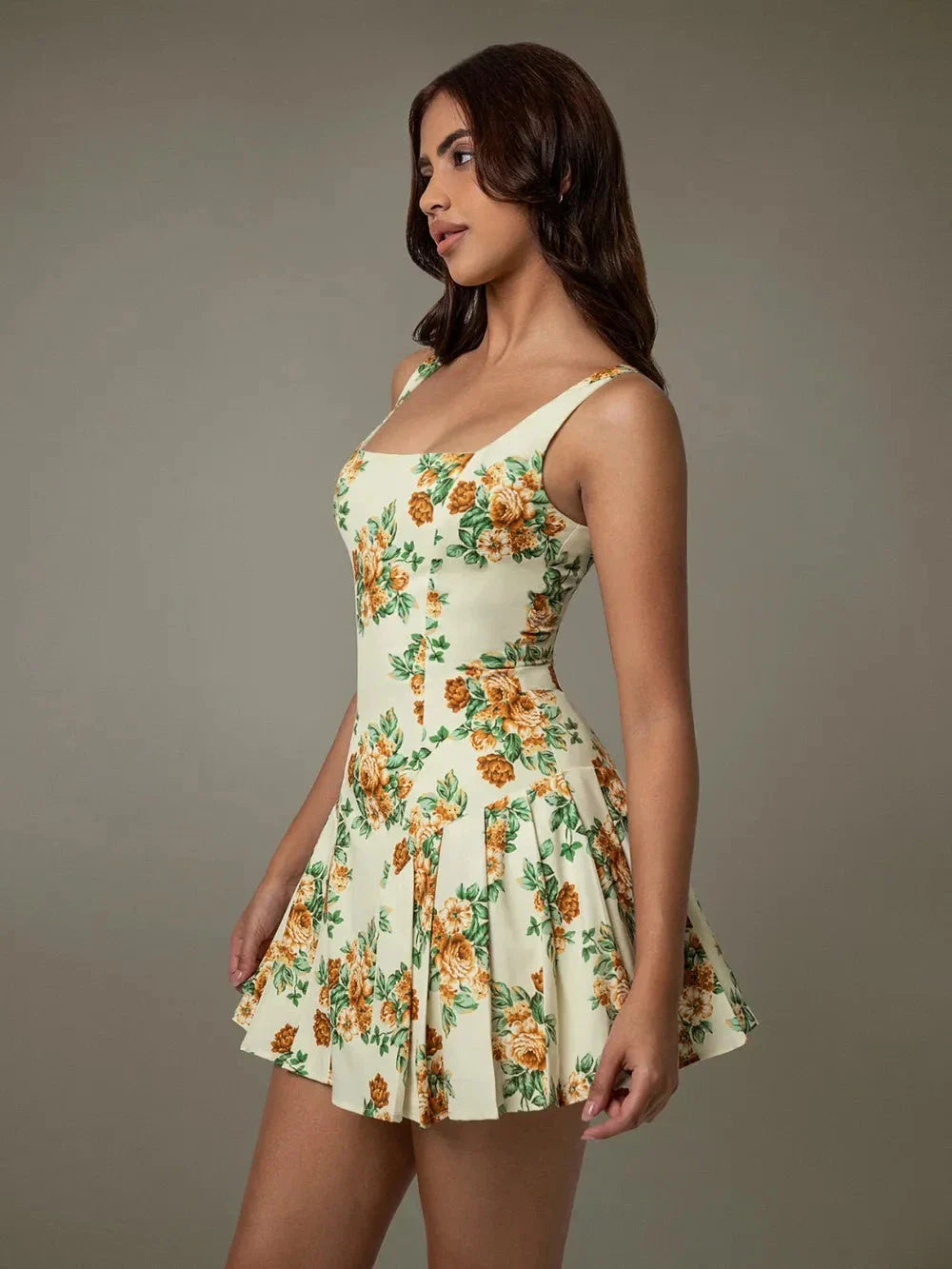 Side view of elegant sleeveless pleated floral mini dress for women – perfect for summer Blossom Breeze Mini Dress