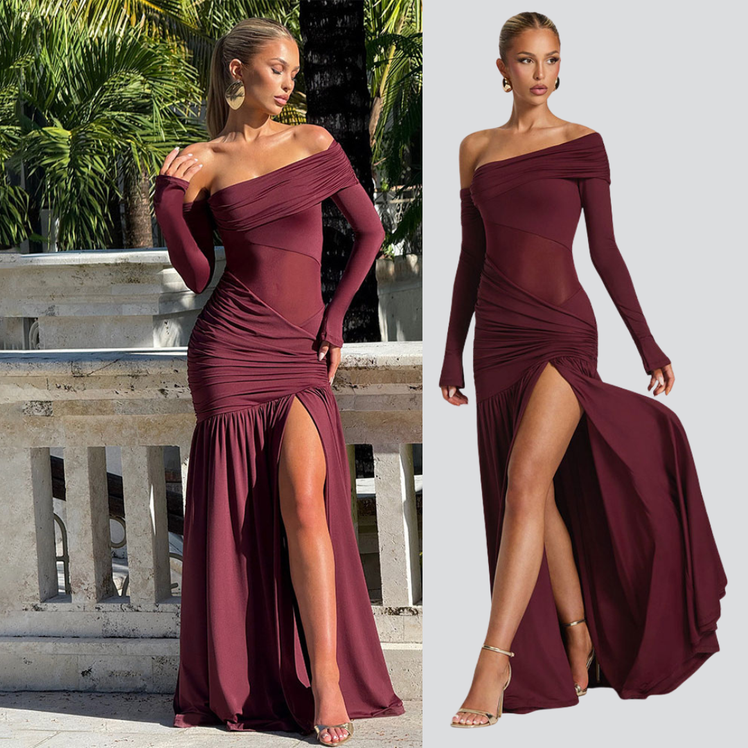 Woman wearing a burgundy off-shoulder dress with a high slit, outdoors.
