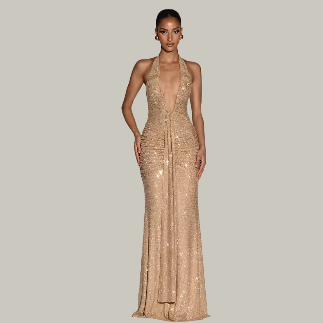 Luxury woman wearing Rosetta gold sparkle maxi gown at an upscale evening event