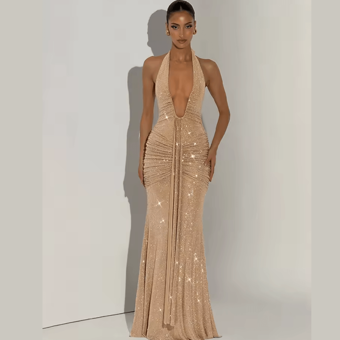 Luxury woman wearing Rosetta gold sparkle maxi gown at an upscale evening event