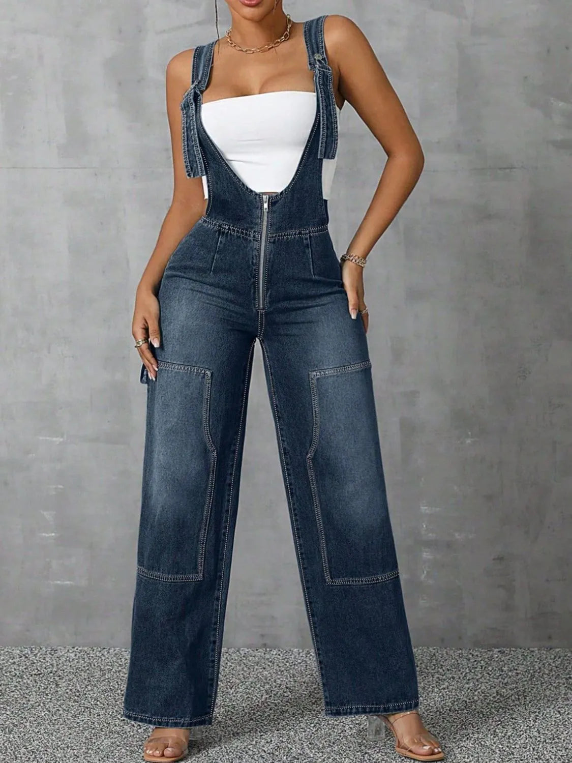 Confident woman in wide-strap zip-front denim overalls – ODI-ONE FASHION
