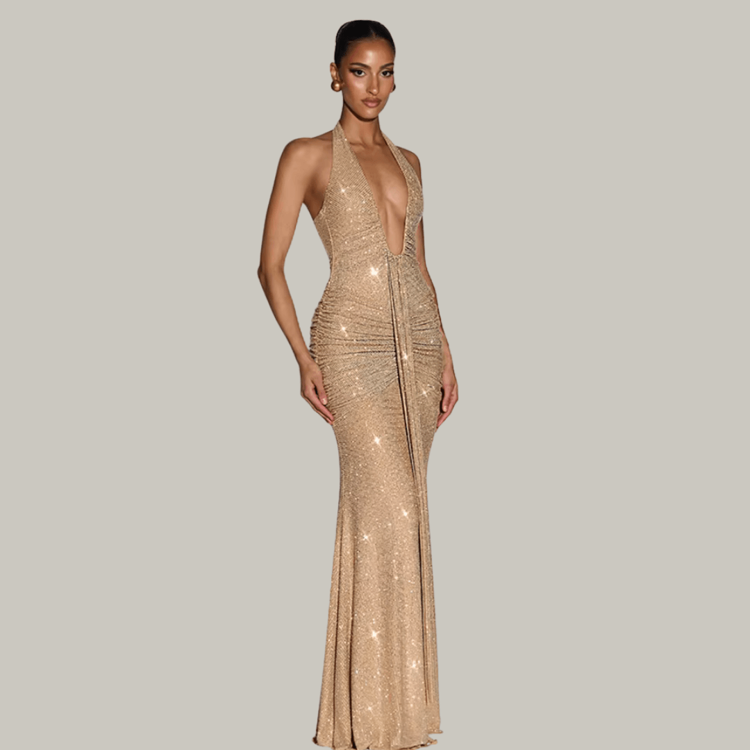 Luxury woman wearing Rosetta gold sparkle maxi gown at an upscale evening event