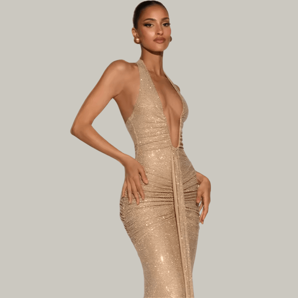 Luxury woman wearing Rosetta gold sparkle maxi gown at an upscale evening event