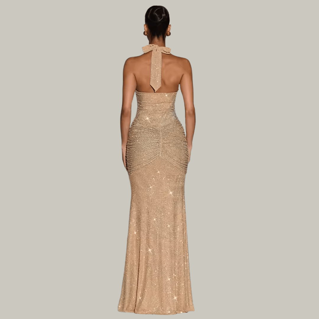 Luxury woman wearing Rosetta gold sparkle maxi gown at an upscale evening event