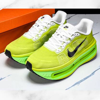 Neon green sneakers with white laces on a marble surface