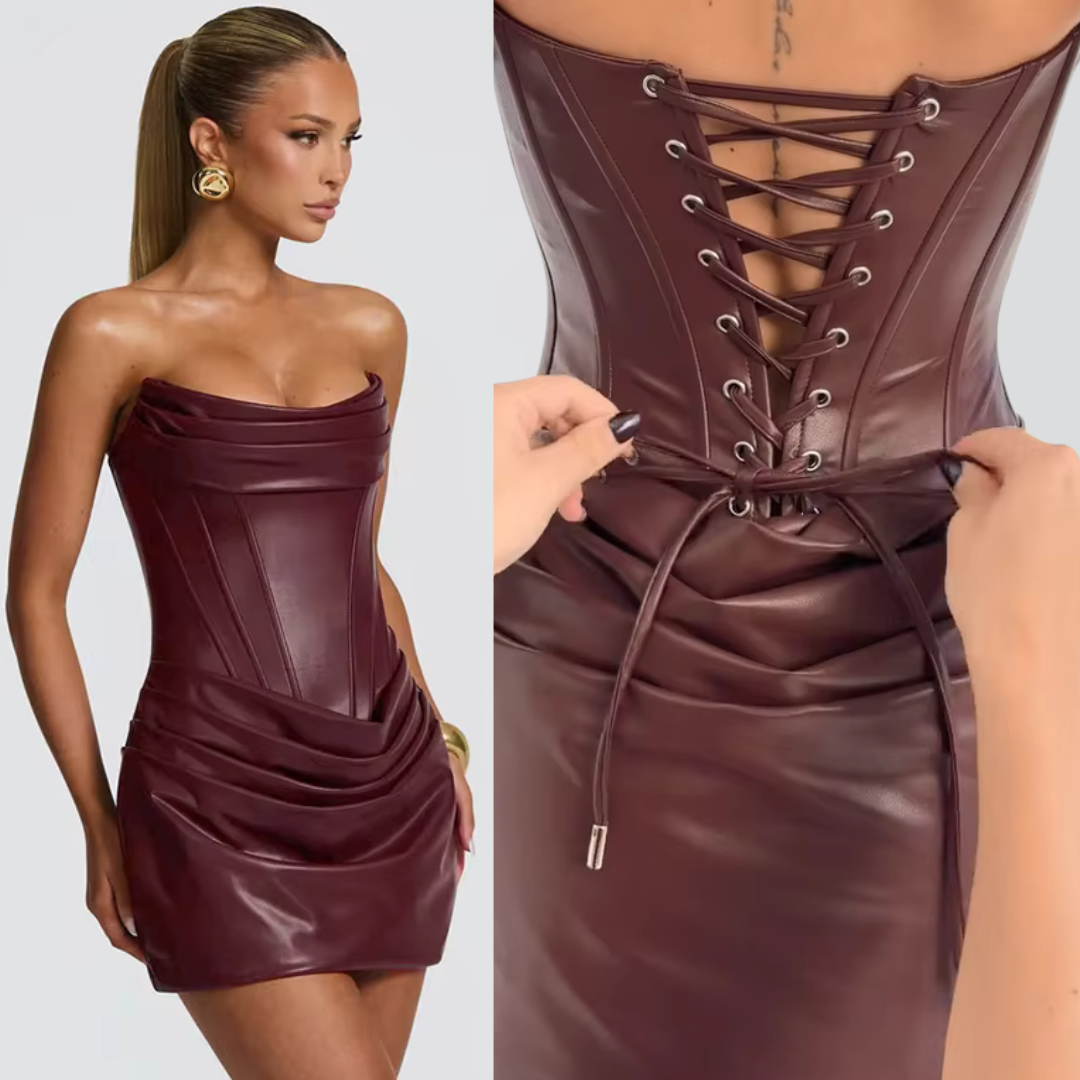 Burgundy leather dress with lace-up front on a plain background